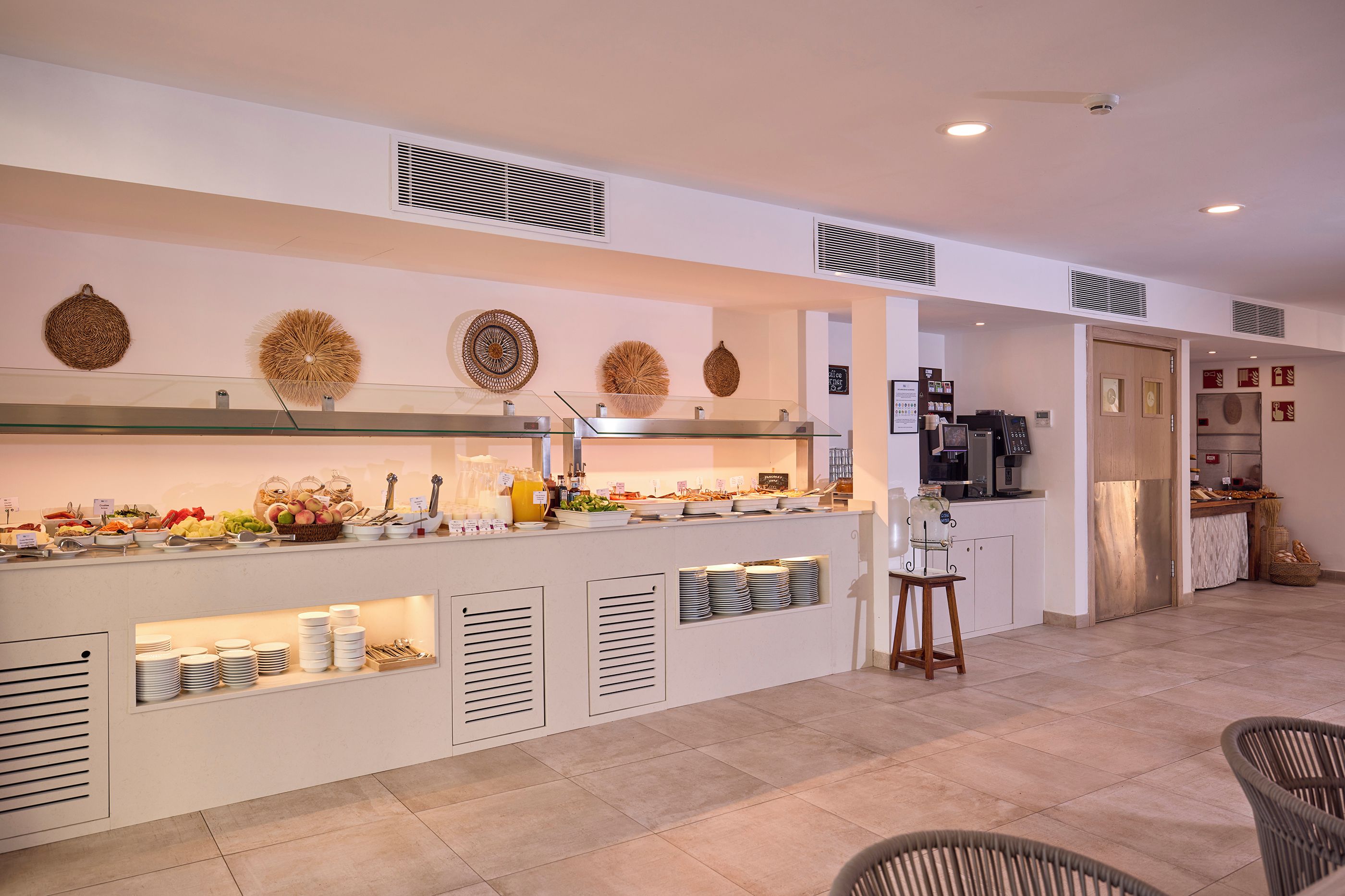 A breakfast bar with various food items and a coffee machine.