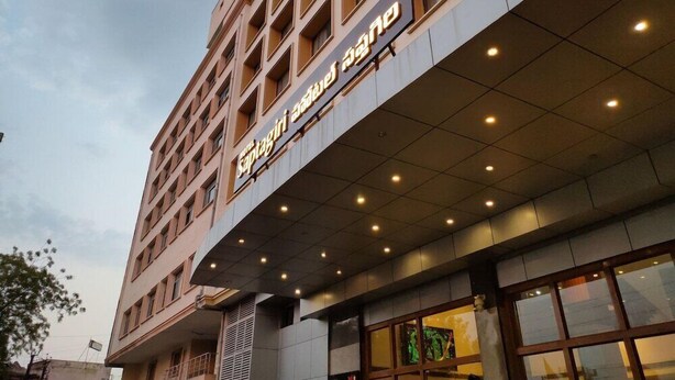A multi-story hotel with a modern facade, featuring a prominent sign with illuminated text. - OYO Premium Secunderabad Station (Hyderabad)