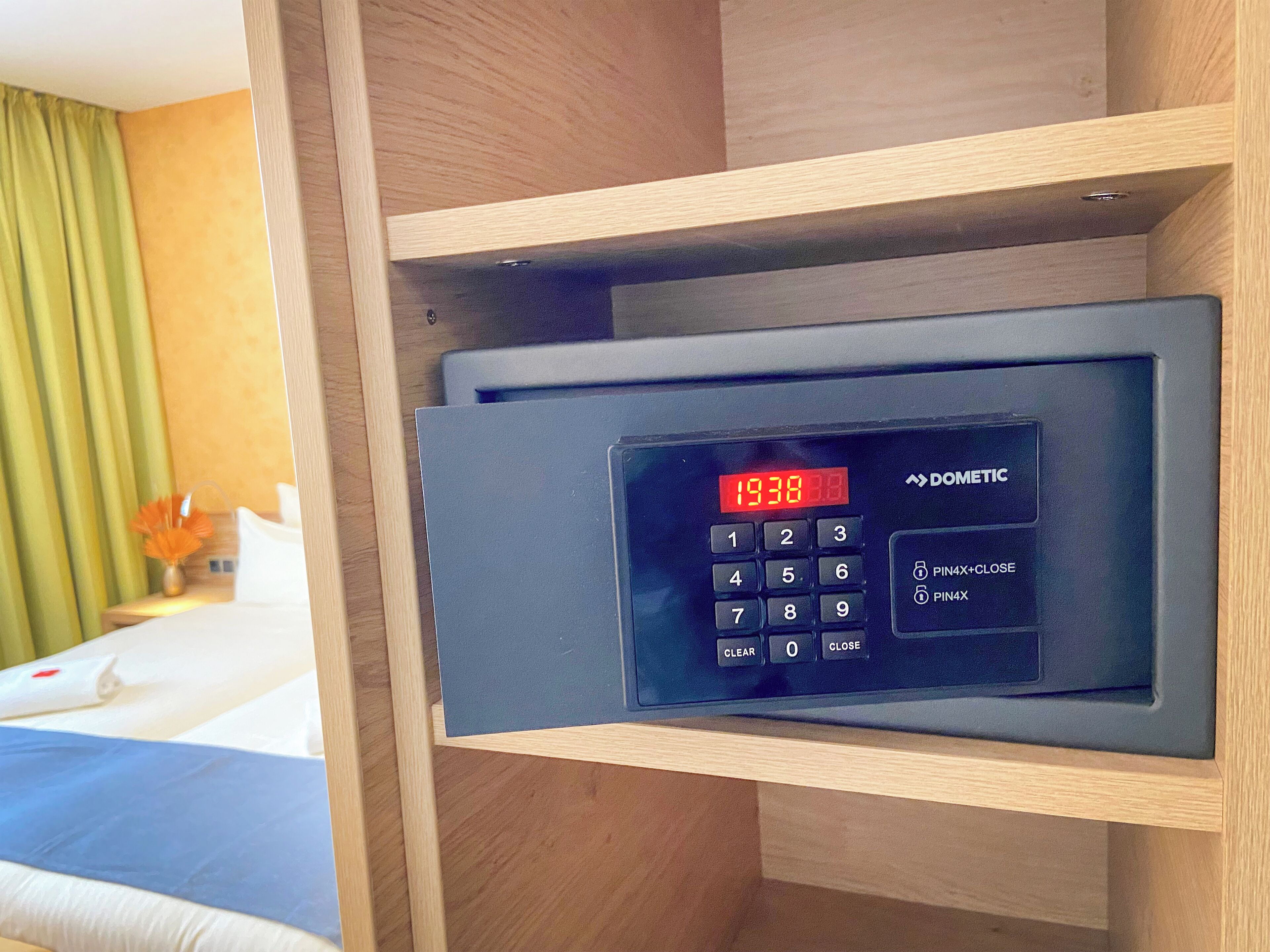 A digital clock on a control panel with the time 19:38.
