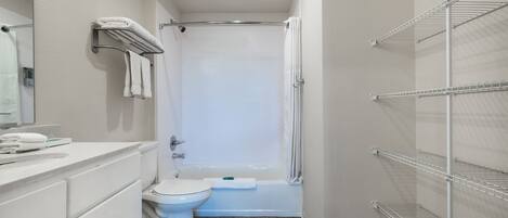 A modern bathroom with a toilet, sink, and shower.