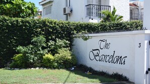 A building with a sign reading "The Barcelona" and a number "3" on the wall. - The Barcelona by Pro Homes Jamaica (Kingston)