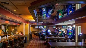 A bar area with multiple gaming machines and a checkered floor.