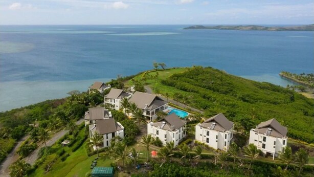 A coastal property with multiple white buildings, a swimming pool, and lush greenery. - Dreamview Villas - In Rakiraki (Rakiraki)