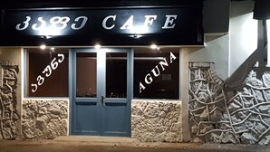 A cafe with a stone facade and a blue door. - Hotel Aguna (Kutaisi)