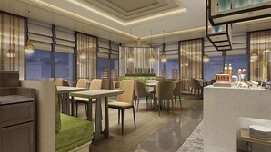 A modern restaurant interior with a central dining area, high ceilings, and pendant lighting. - Howard Johnson Zhujiang Hotel Chongqing (Chongqing)