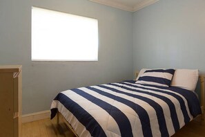 A bedroom with a bed, a window, and a door. - Tropical Oasis Estate (Pinecrest)