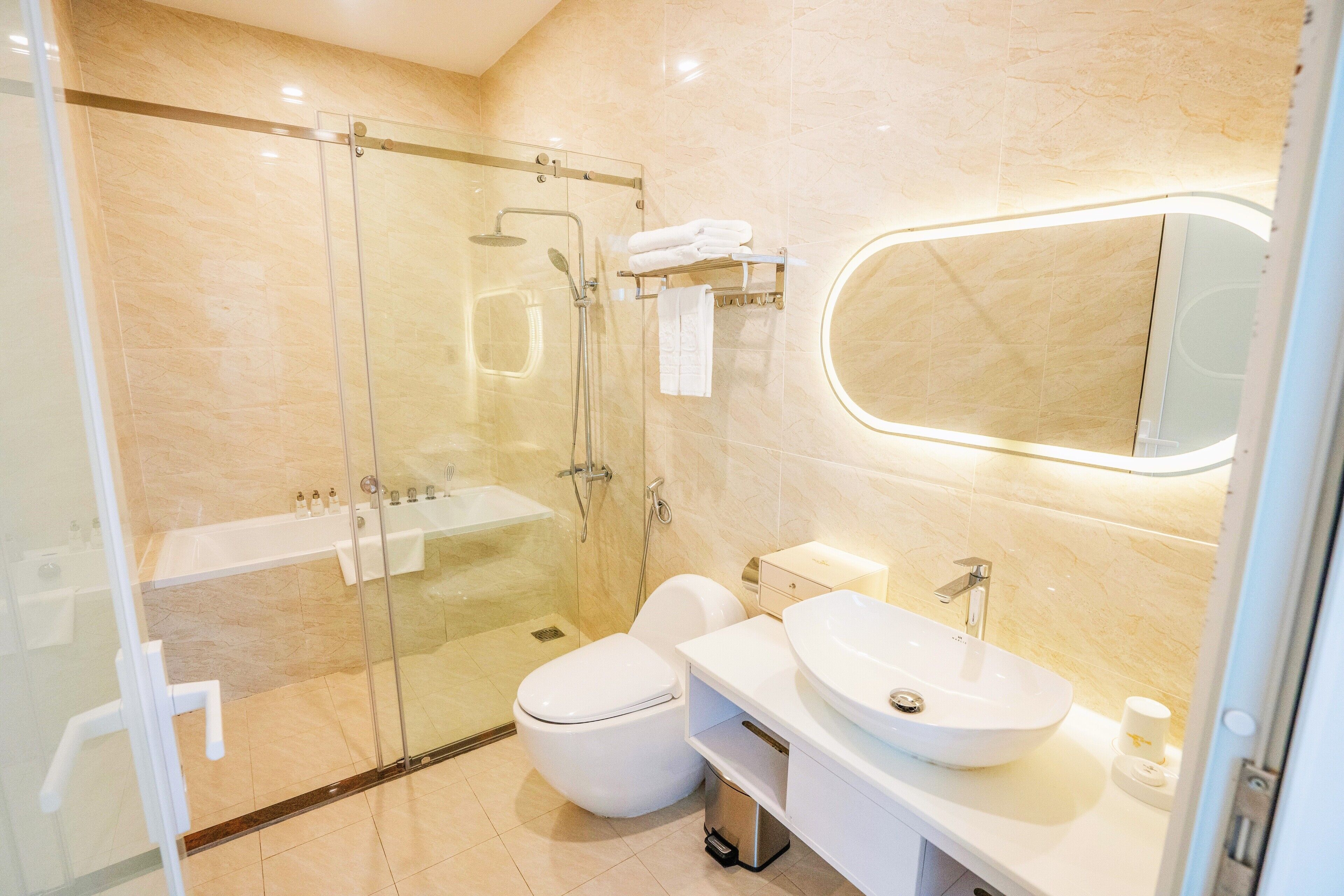 A modern bathroom with a glass-enclosed shower, a white toilet, a sink, and a vanity.