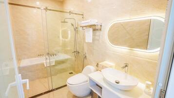 A modern bathroom with a glass-enclosed shower, a white toilet, a sink, and a vanity.