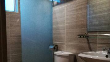 A bathroom with a toilet, sink, and towel rack.