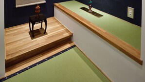 A traditional Japanese room with tatami flooring, a shoji screen, a calligraphy piece, and a small wooden table. - Cochi-en (Kyoto)