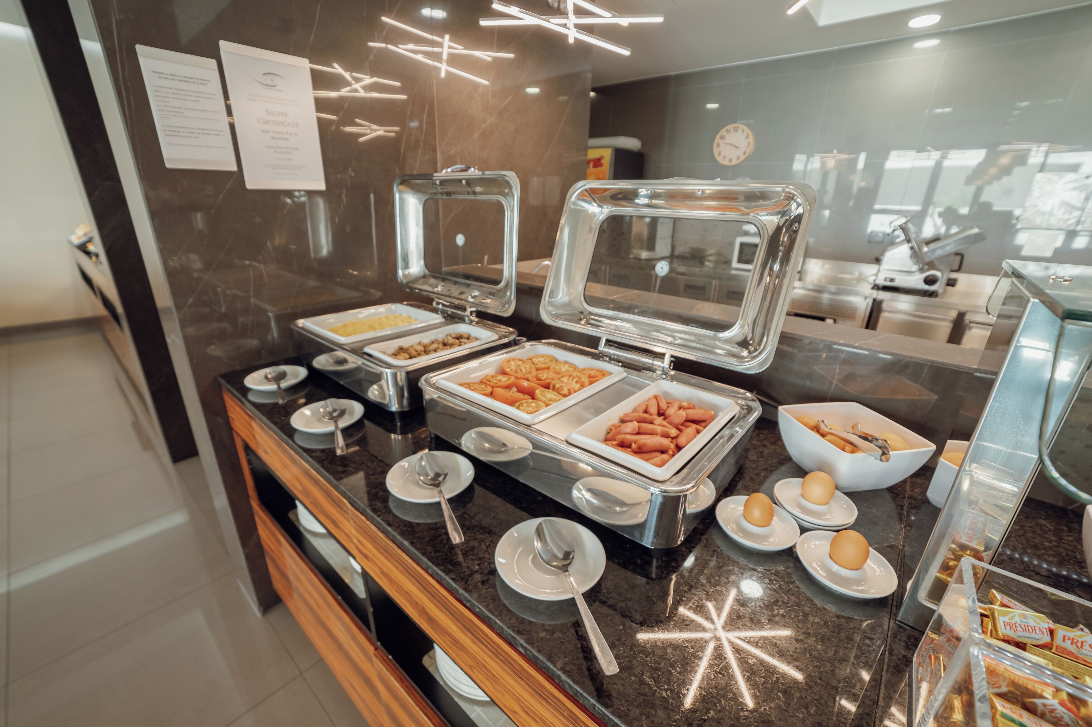 A buffet area with various food items and serving utensils.