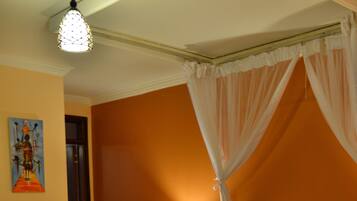Una habitación de hotel con una cama, una mesita de noche, una lámpara y un cuadro en la pared.