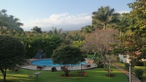 A pool surrounded by lush greenery and a clear sky. - Kilemakyaro Mountain Lodge (Moshi)