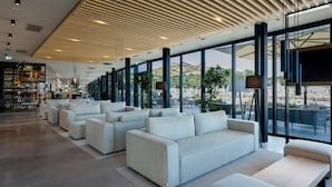 A modern lounge area with sofas and a bar.