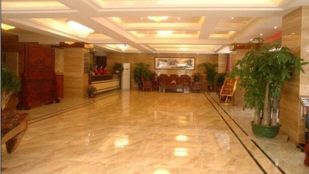 A spacious lobby with a polished marble floor, a reception desk, and several potted plants. - Jintang Hotel Guangzhou (Guangzhou)
