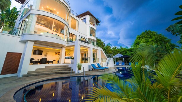 A multi-story modern house with a swimming pool, large windows, and a balcony. - White Stone (Koh Samui)