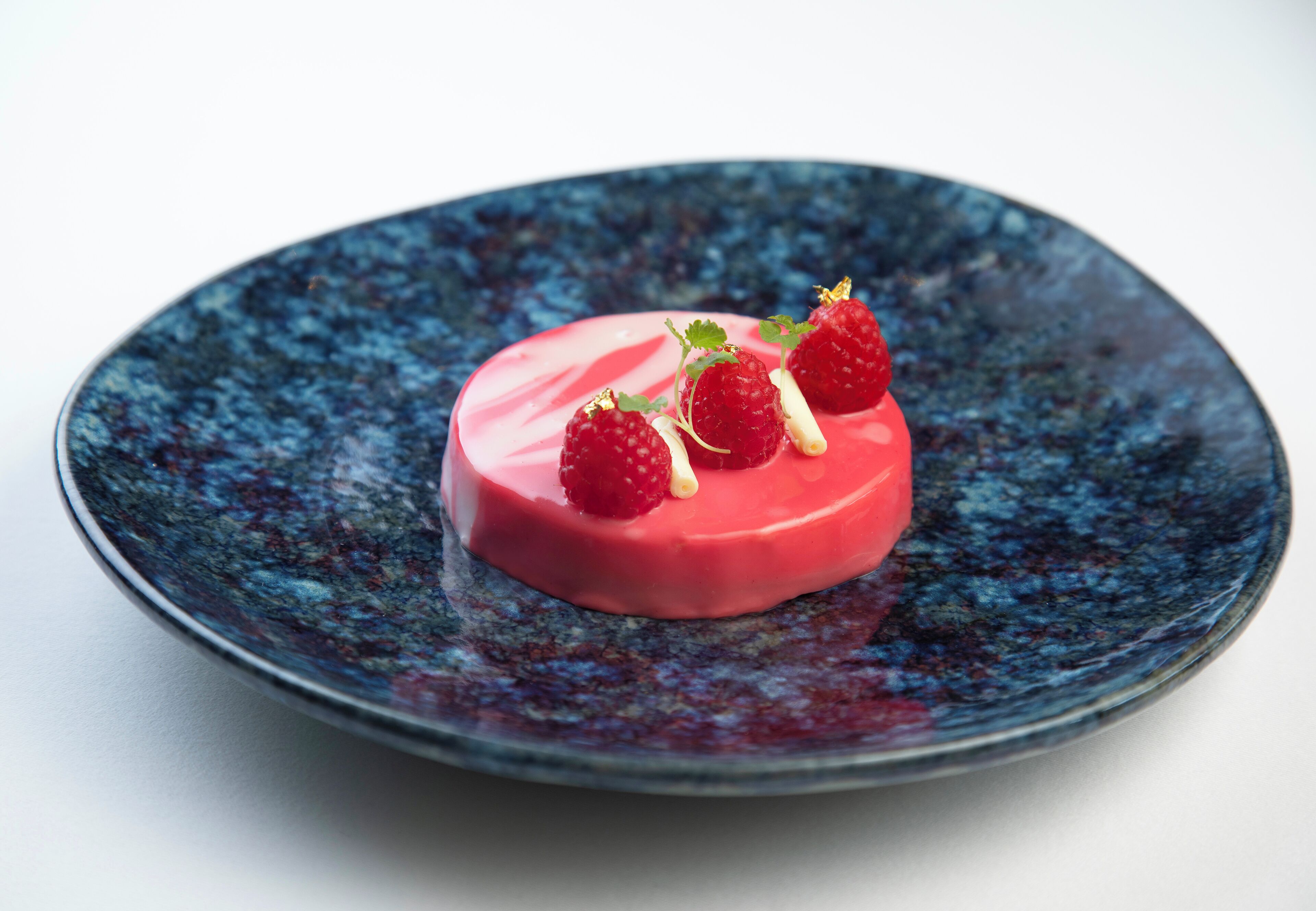 A dessert on a dark blue plate.