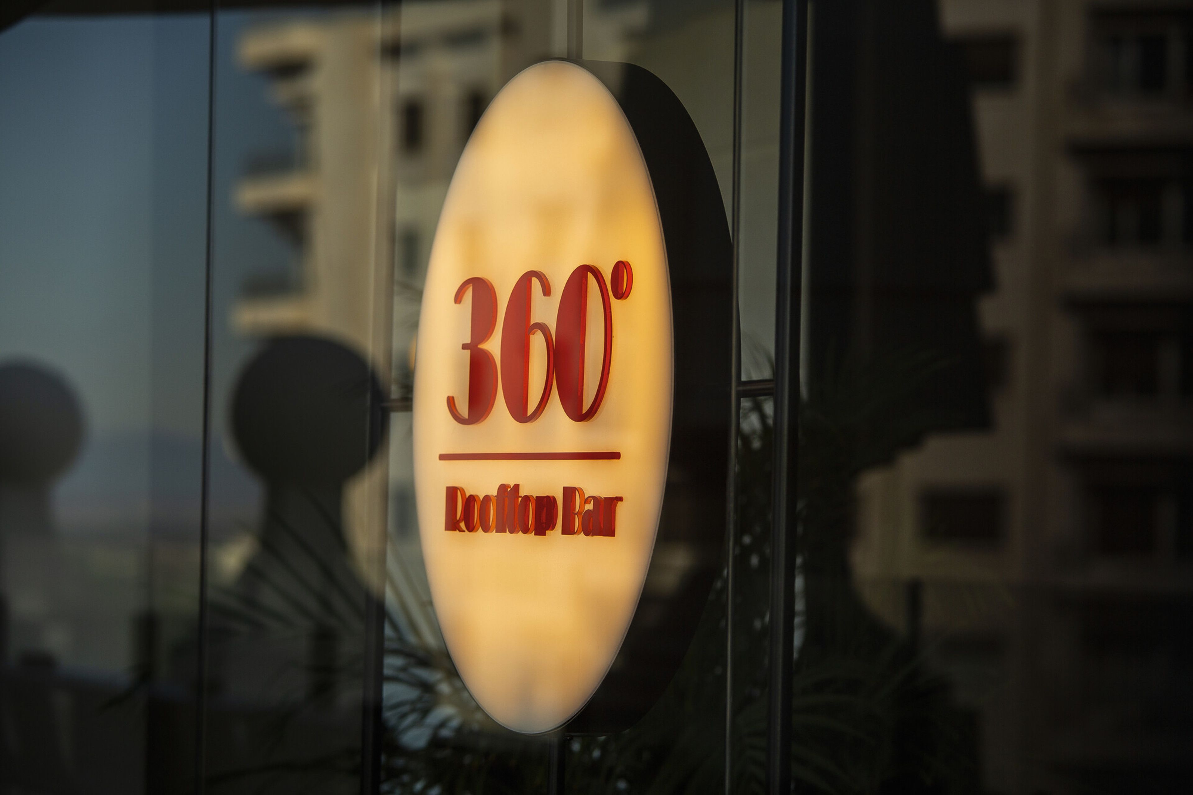 A sign with "360° Rooftop Bar" indicating a bar with a panoramic view.