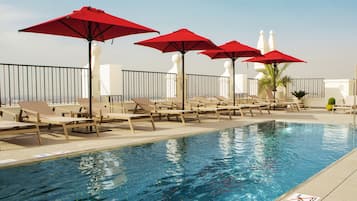 Seasonal outdoor pool, pool umbrellas, pool loungers