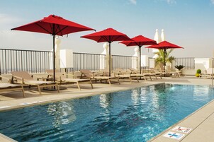 Seasonal outdoor pool, open 10:00 AM to 7:00 PM, pool umbrellas