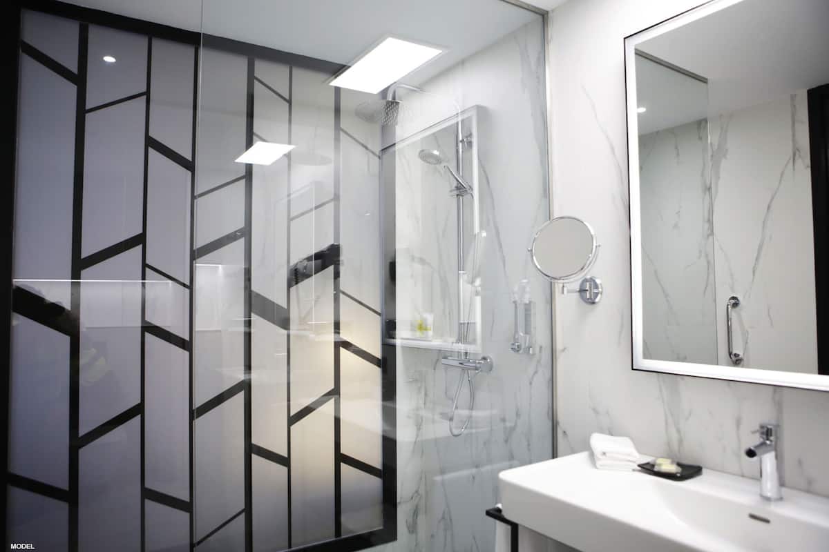 deluxe room (superior king) | bathroom | shower, rainfall showerhead, eco-friendly toiletries, hair dryer