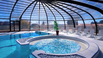 Indoor pool, pool umbrellas, pool loungers