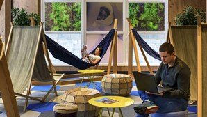 A room with hammocks, a laptop, and a person sitting on a stool. - ibis Sao Paulo Tatuape (São Paulo)