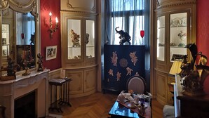 A room with ornate decor, including a fireplace, a mirror, and a window with curtains. - La Résidence des Indes - Chambres d'hotes (La Rochelle)