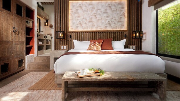 A modern bedroom with a large bed, wooden headboard, and a view of greenery through a window. - H21 Hospedaje Boutique (Mexico City)