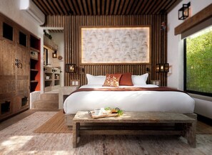 A modern bedroom with a large bed, wooden headboard, and a view of greenery through a window.