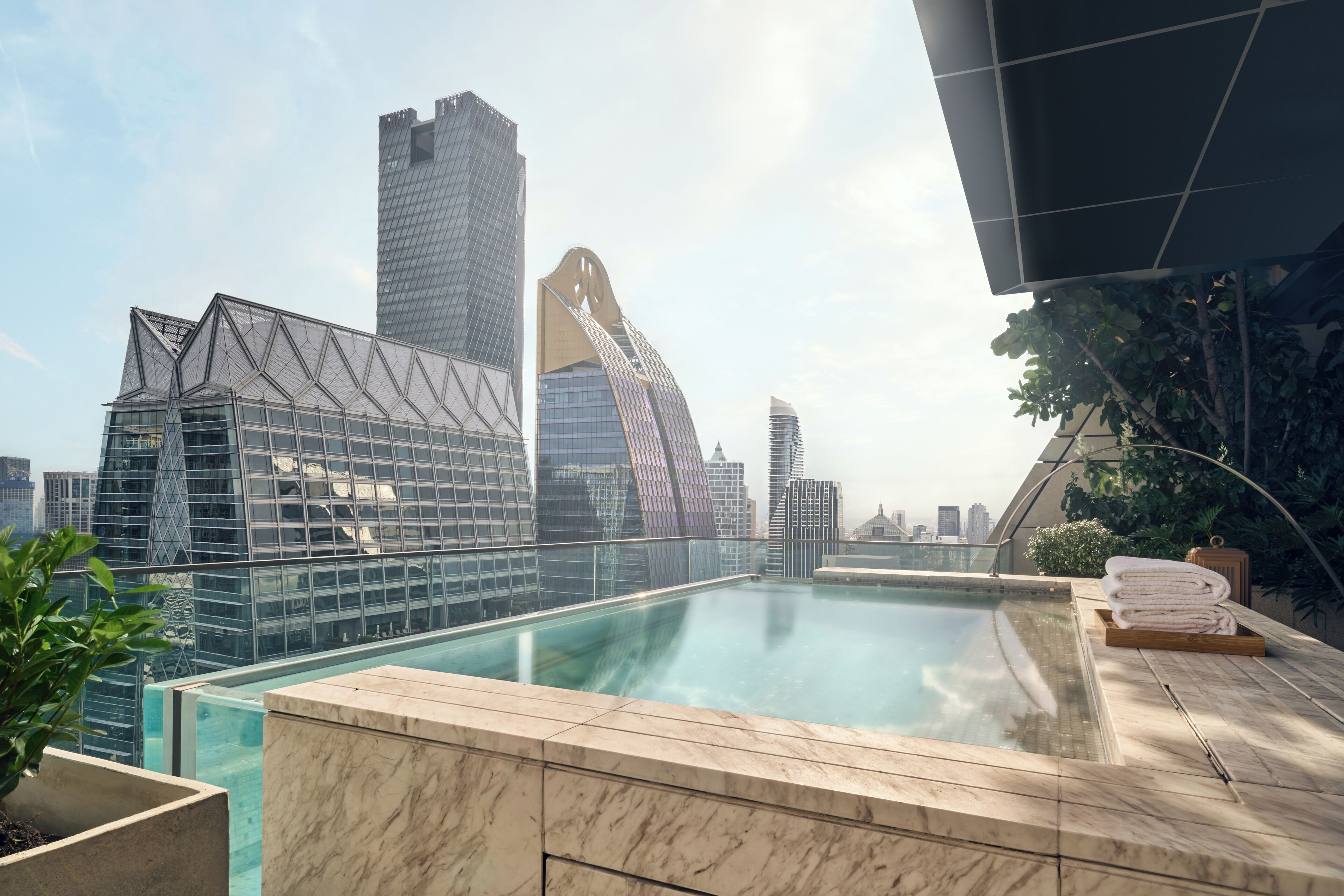 A rooftop pool with a city skyline in the background.
