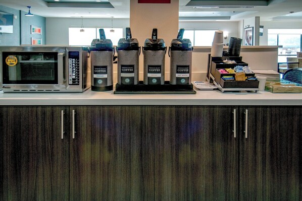 A coffee station with a microwave, coffee makers, and a water dispenser. - TownePlace Suites by Marriott Vidalia Riverfront (Vidalia)