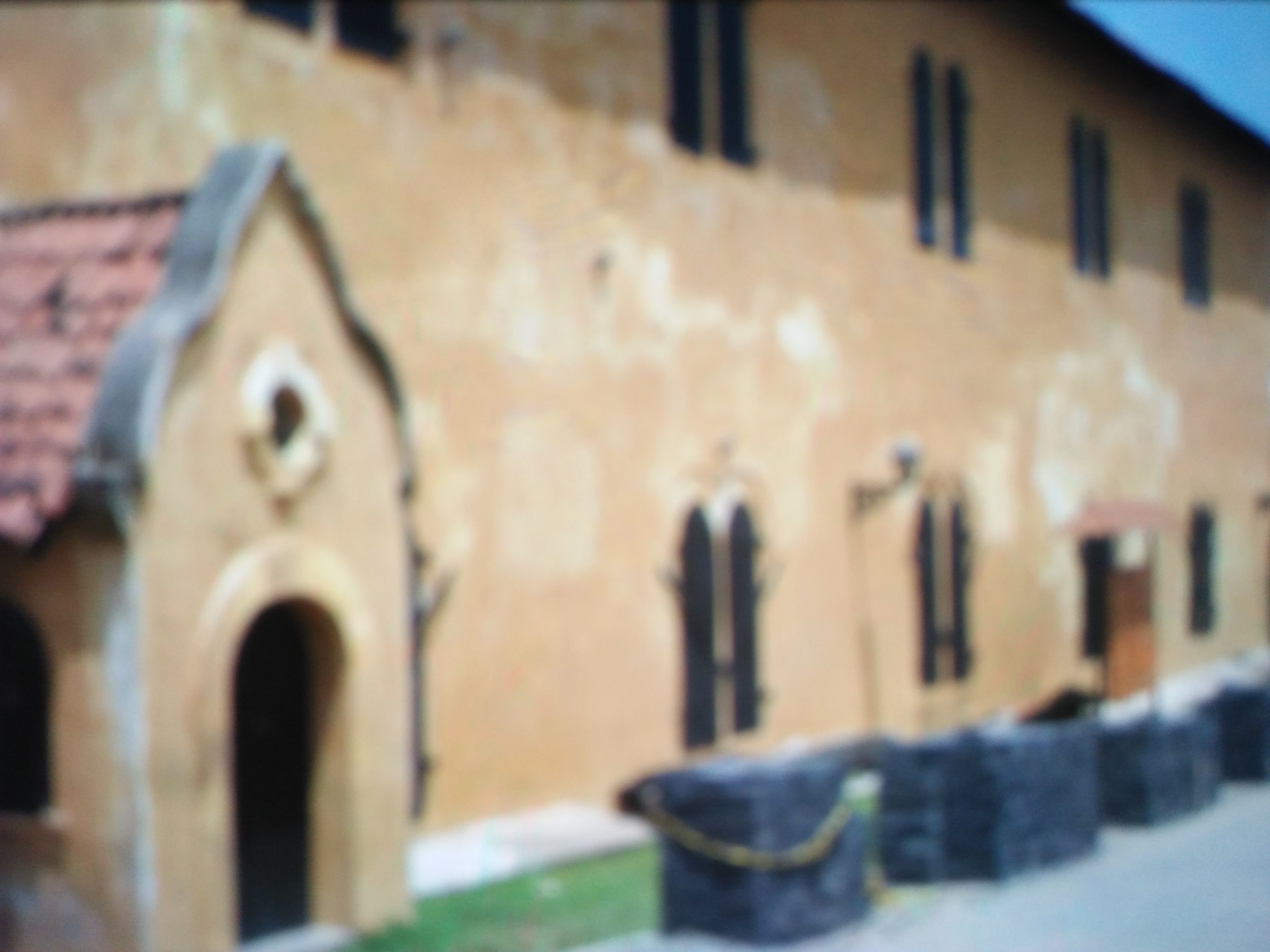 A building with a distinctive arched entrance and multiple windows.