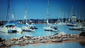 A marina with multiple sailboats docked. - White House (Unawatuna)