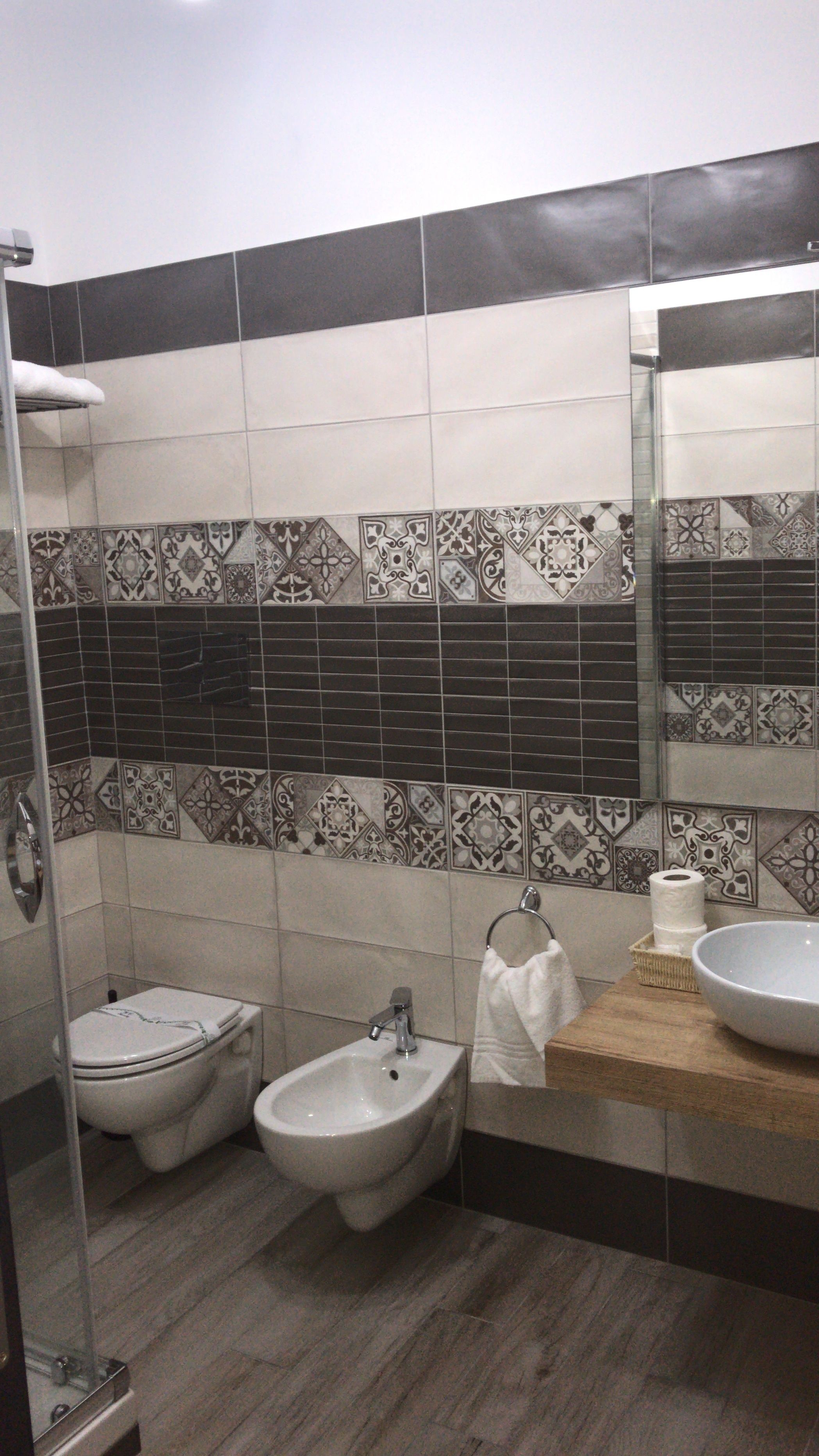 A bathroom with a bidet, a sink, and a mirror.