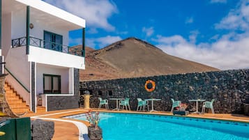 Relax by the pool surrounded by a scenic view of the surrounding landscape.