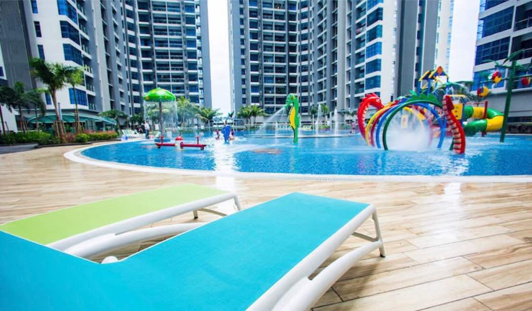 A swimming pool area with water slides and lounge chairs.