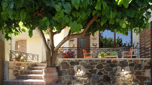 A stone staircase leading to a building with a wooden railing and potted plants. - Valena Stylish Home -15 min to Elafonisi (Kissamos)