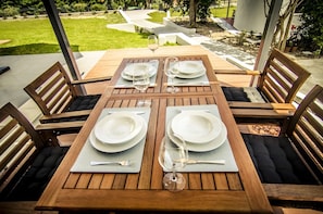 Enjoy al fresco dining in a beautifully set outdoor space with a garden view.