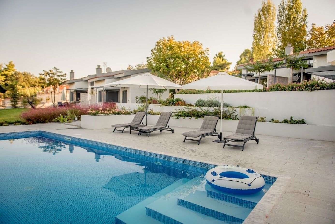 Seasonal outdoor pool, pool umbrellas, pool loungers