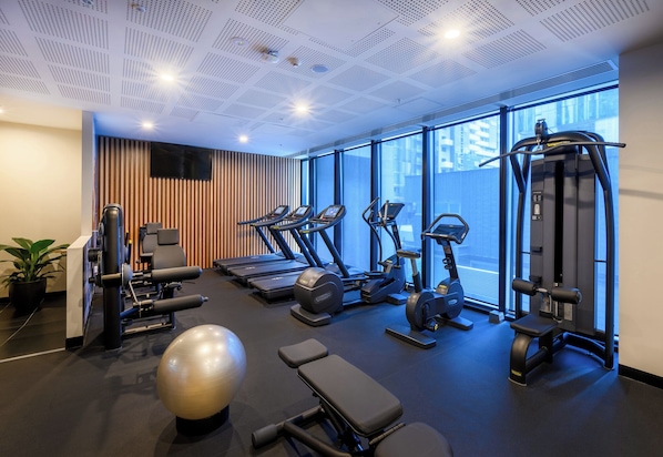 A modern gym with treadmills, elliptical machines, and weightlifting equipment. - ibis Melbourne Central (Melbourne)