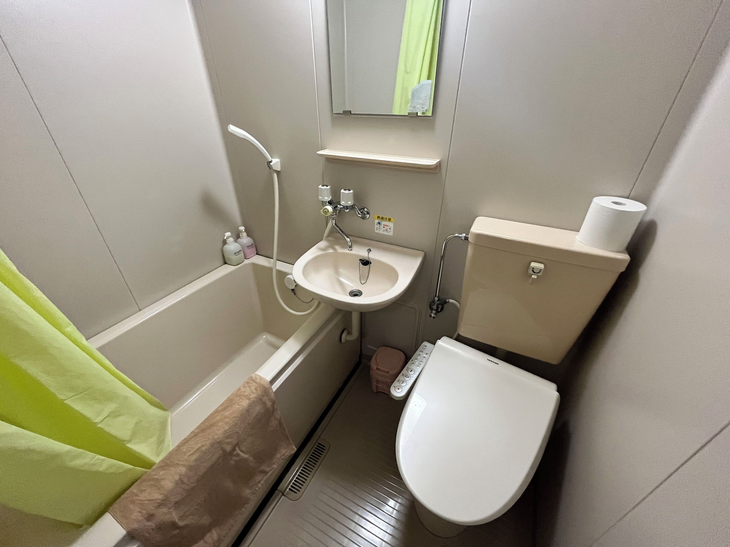 A small bathroom with a bathtub, a sink, and a toilet.