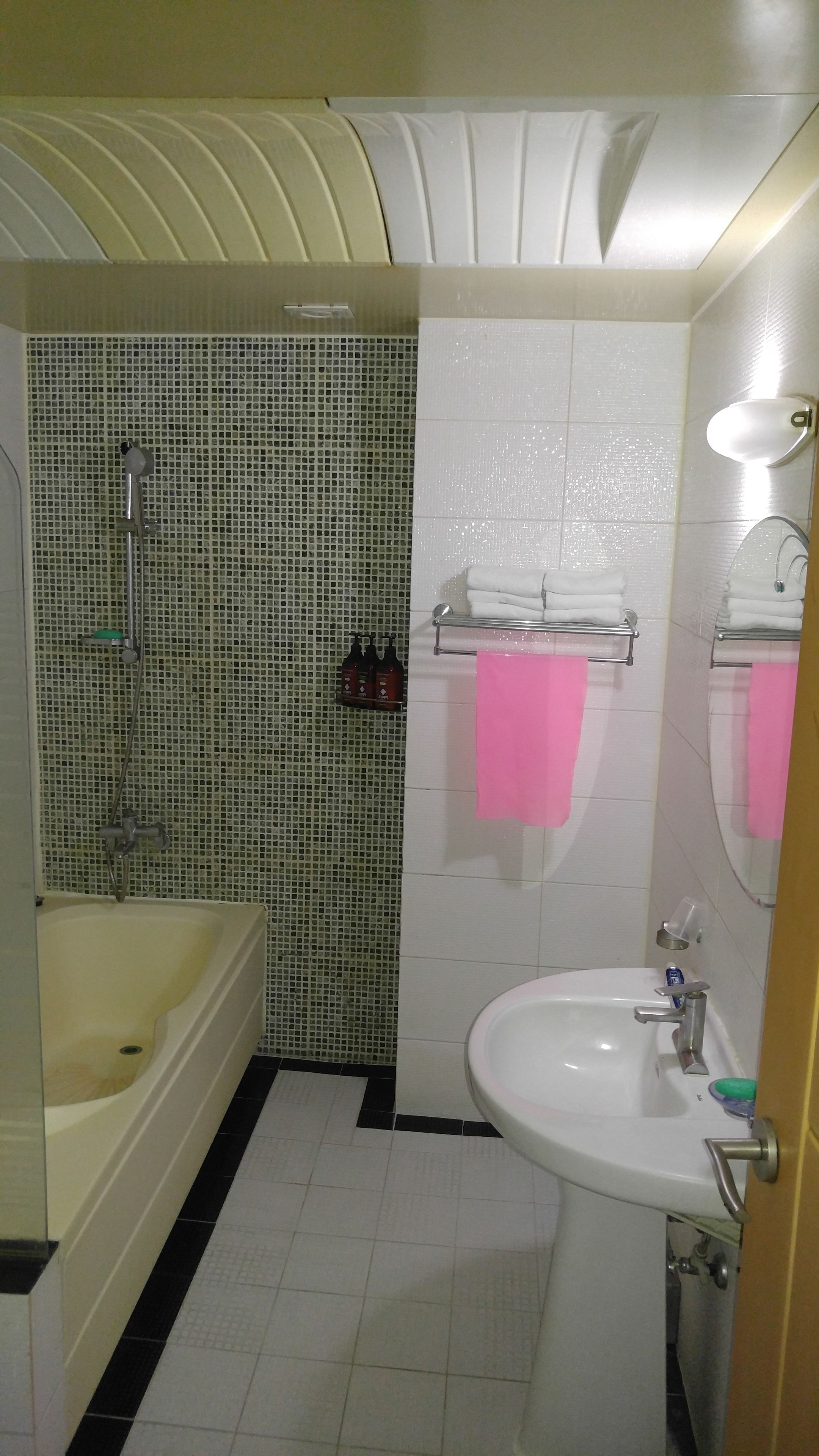 A bathroom with a bathtub, a sink, and a shower.