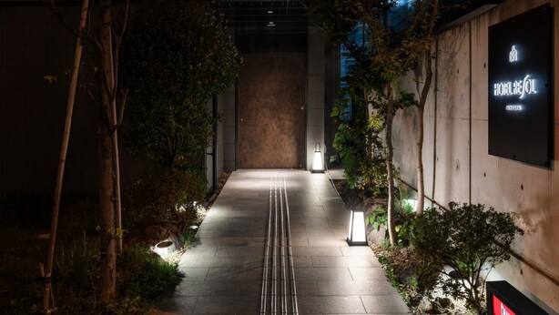 A nighttime pathway leading to a building with a sign reading "HOTEL REFUL." - Hotel Resol Akihabara (Tokyo)