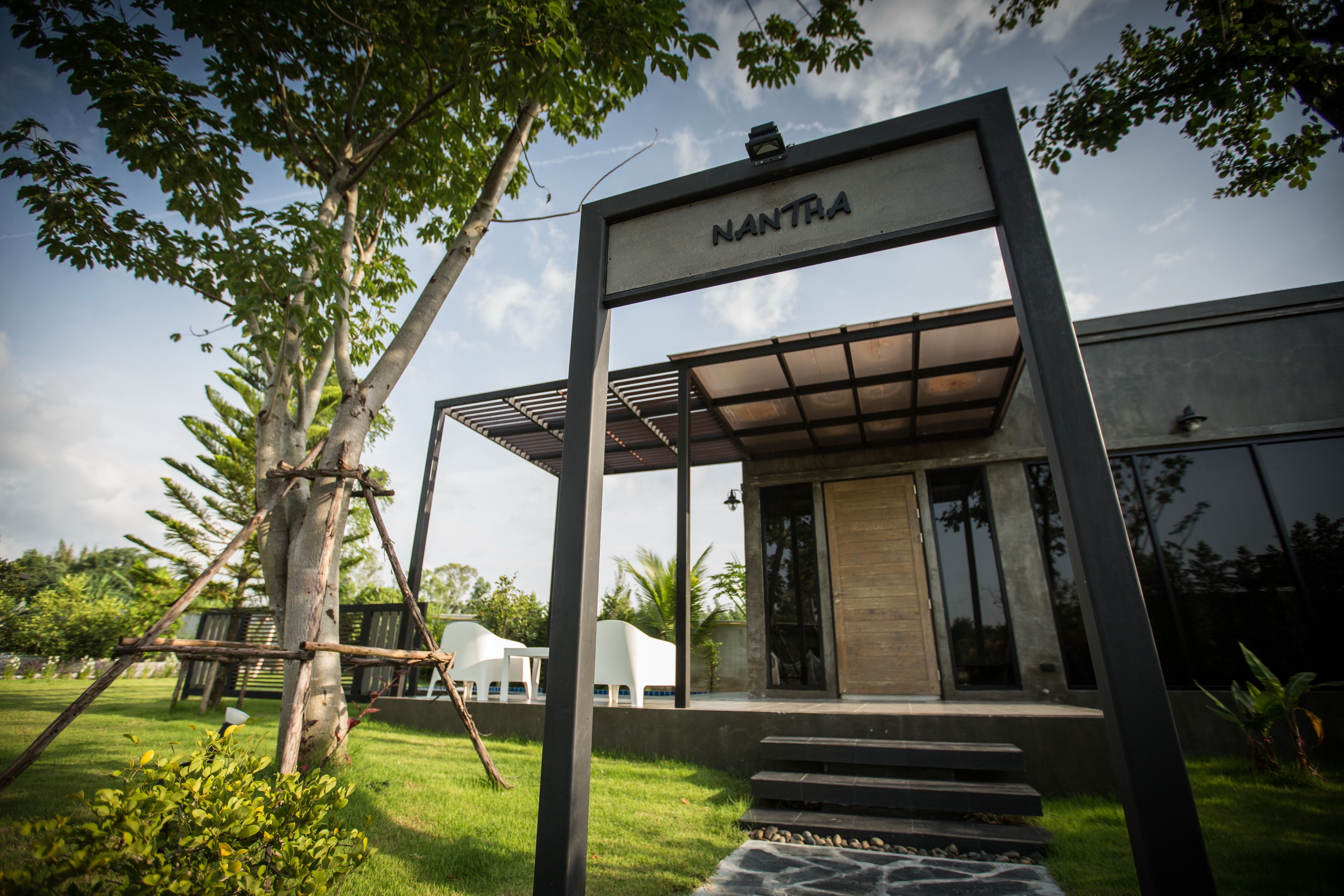 A modern building with a sign reading "NANTRA" and a covered entrance.