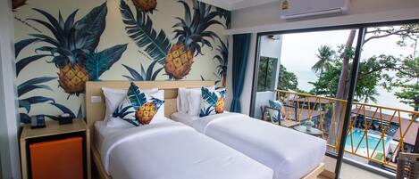 A hotel room with two beds, a large window with a view of a pool and palm trees, and a tropical-themed wall mural.