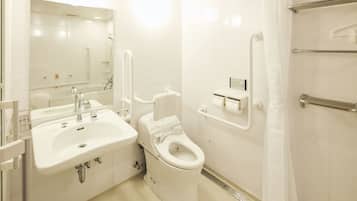A modern bathroom with a sink, toilet, and shower.