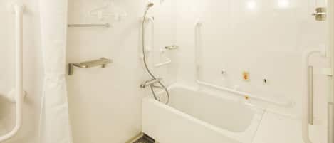 Un baño moderno con cabina de ducha, barras de apoyo y bañera.