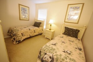 A bedroom with two beds, each with a panda-themed bedspread, a bedside table with a lamp, and framed pictures on the walls. - Ly53780 - Emerald Island - 7 Bed 4.5 Baths Villa (Kissimmee)