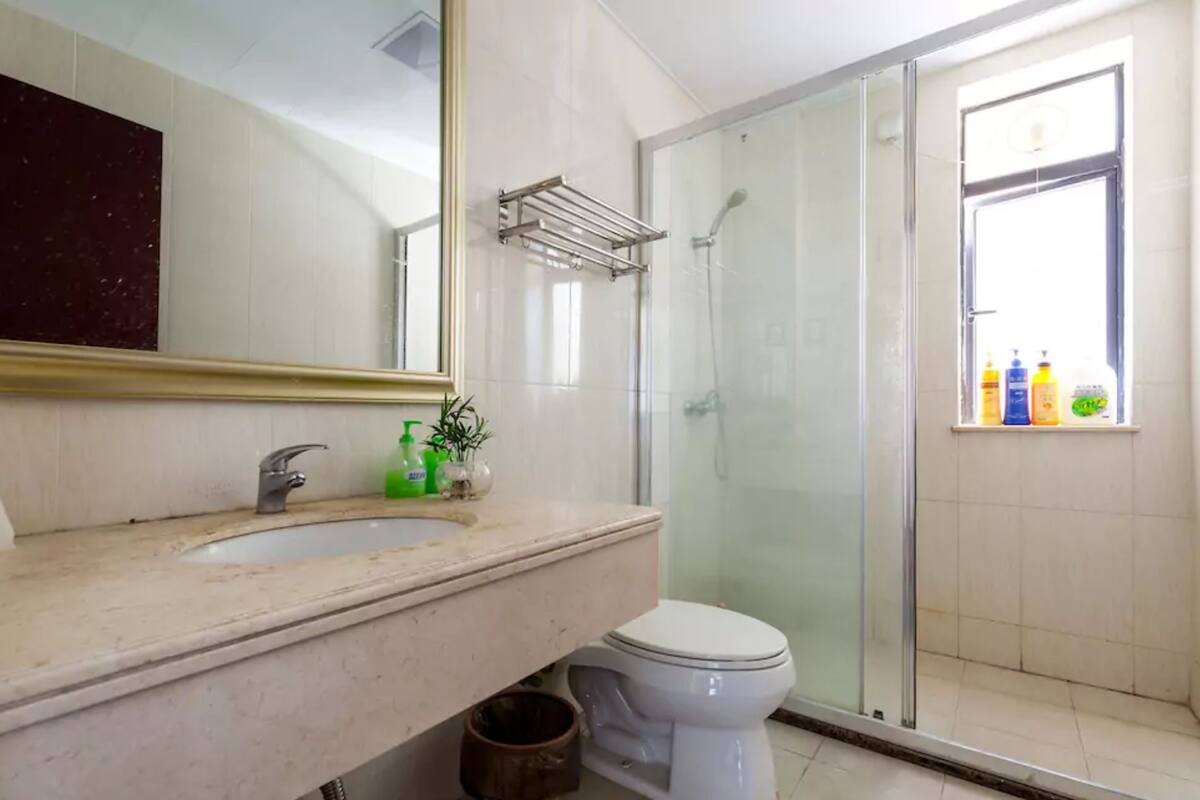 Shower, hair dryer, slippers, towels